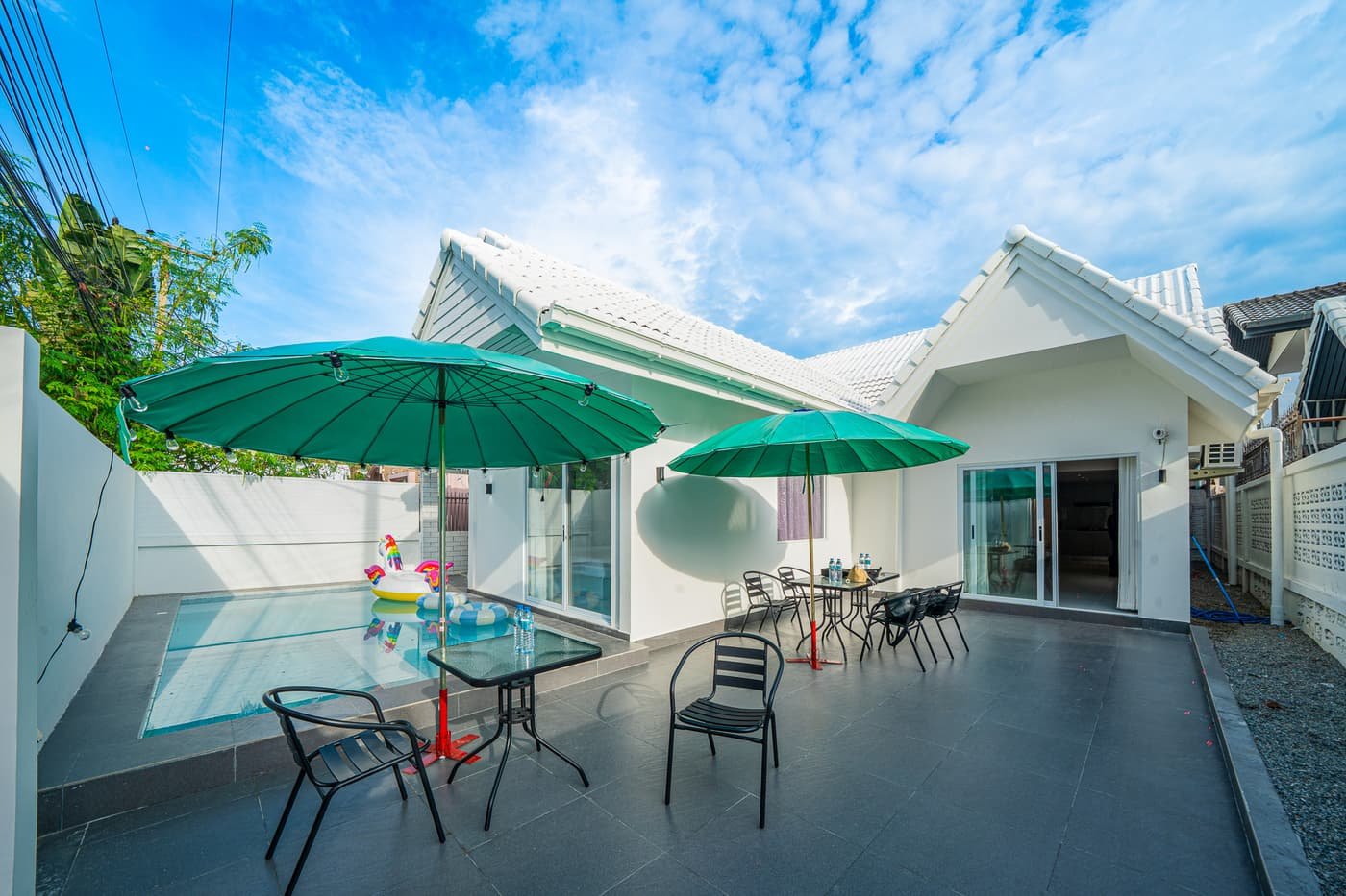 Poolside sun loungers with resort umbrellas